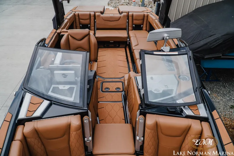Slide: The Image of 2021 Malibu M240 boat interior with luxurious brown leather seating at Lake Norman Marina. - 19