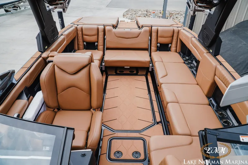 Slide: The Image of 2021 Malibu M240 boat interior with luxurious tan leather seating at Lake Norman Marina. - 20