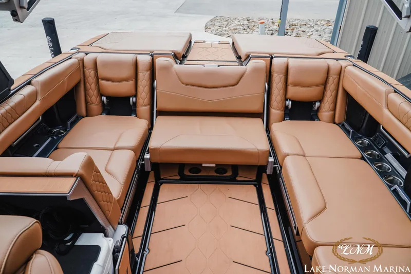 Slide: The Image of Luxurious interior of 2021 Malibu M240 boat with tan leather seating at Lake Norman Marina. - 21