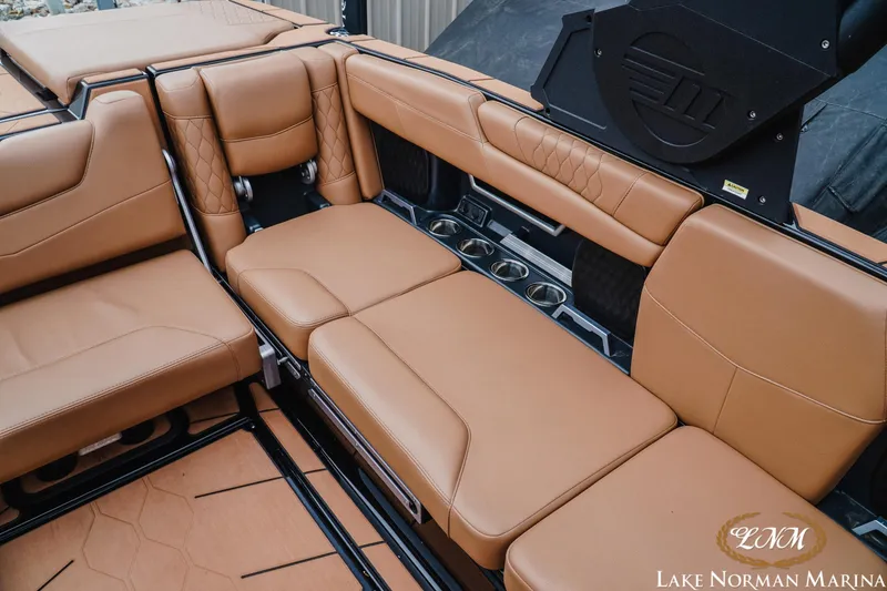 Slide: The Image of Luxurious tan leather seating in a 2021 Malibu M240 boat interior at Lake Norman Marina. - 22