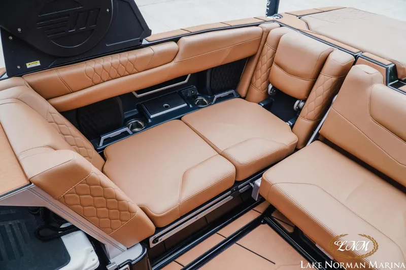 Slide: The Image of Luxurious tan leather seating in 2021 Malibu M240 boat interior. - 23