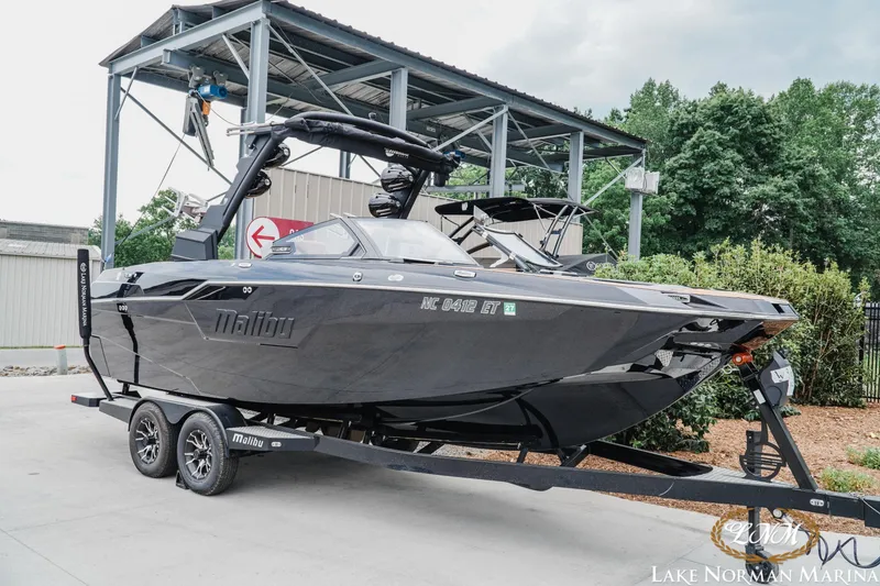 Slide: The Image of 2021 Malibu M240 boat on trailer at Lake Norman Marina, ready for adventure. - 3
