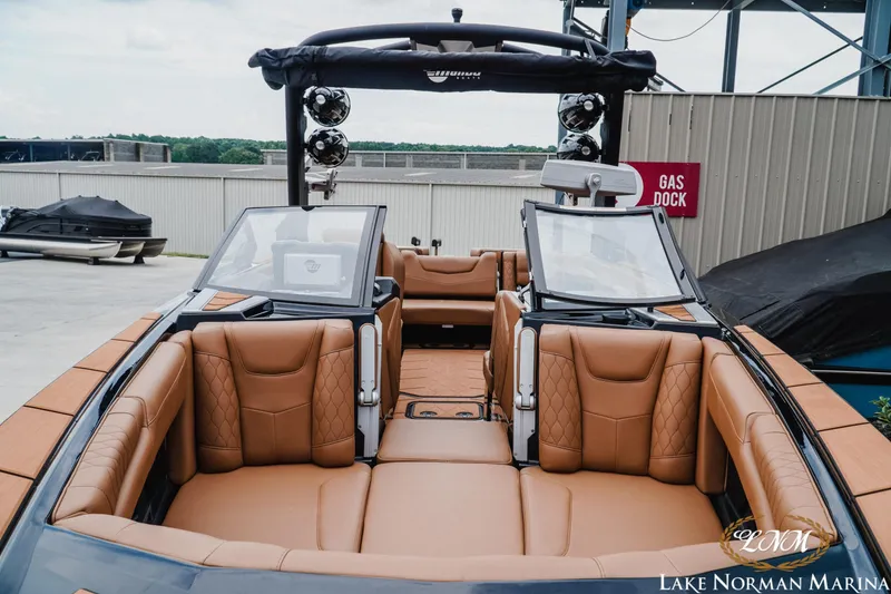 Slide: The Image of 2021 Malibu M240 boat with luxurious tan leather seating at Lake Norman Marina. - 5