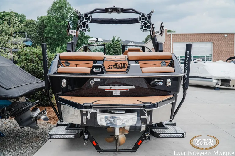Slide: The Image of 2021 Malibu M240 boat at Lake Norman Marina, showcasing sleek design and advanced features. - 7