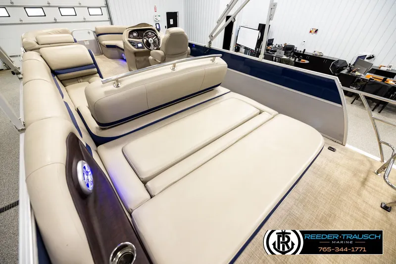 Slide: The Image of 2019 Berkshire 24 SB2 CTS pontoon boat interior with beige seating and modern dashboard. - 11
