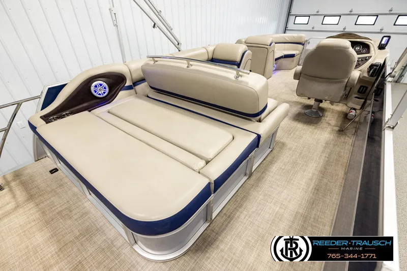 Slide: The Image of 2019 Berkshire 24 SB2 CTS pontoon boat interior with beige seating and modern dashboard. - 12