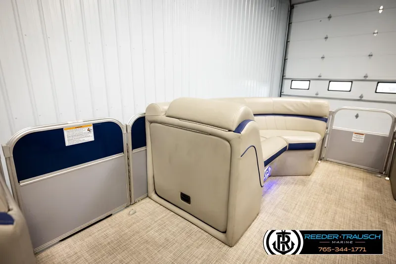 Slide: The Image of 2019 Berkshire 24 SB2 CTS pontoon boat interior with beige seating and blue accents. - 23