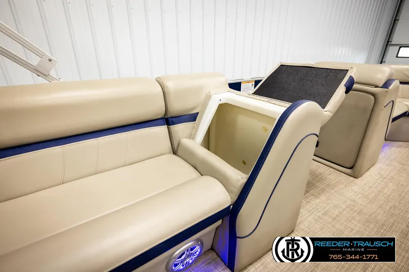 Slide: The Image of 2019 Berkshire 24 SB2 CTS boat interior with beige seating and storage compartment. - 26