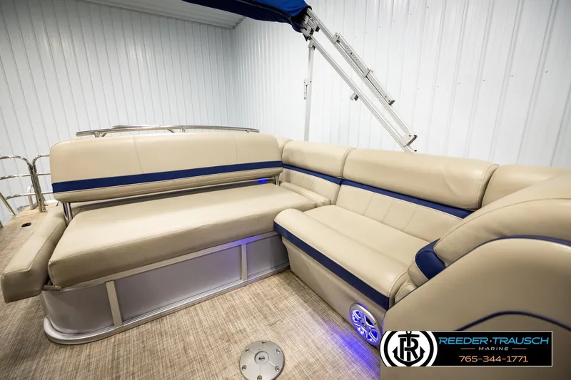 Slide: The Image of 2019 Berkshire 24 SB2 CTS pontoon boat interior with beige seating and blue accents. - 28