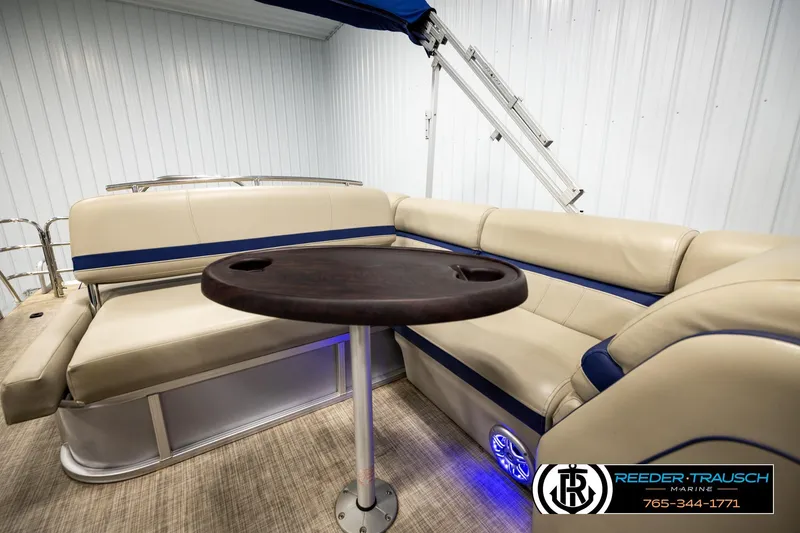 Slide: The Image of 2019 Berkshire 24 SB2 CTS pontoon boat interior with beige seating and dark wood table. - 29