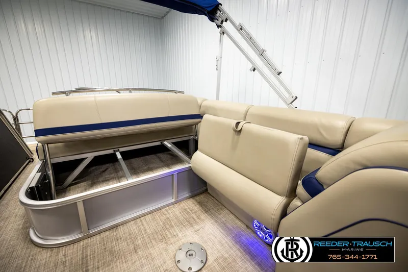 Slide: The Image of 2019 Berkshire 24 SB2 CTS pontoon boat interior with beige seating and blue accents. - 30