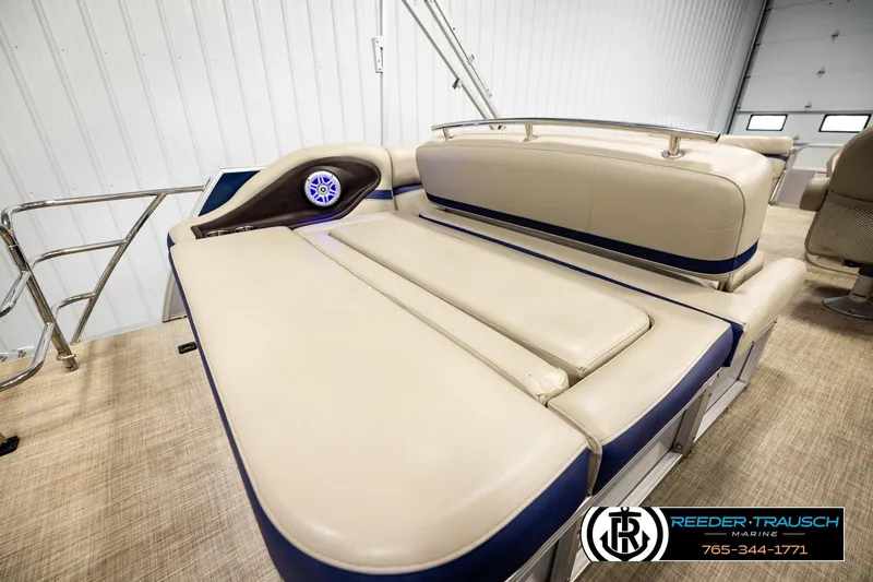 Slide: The Image of 2019 Berkshire 24 SB2 CTS boat interior with beige seating and blue accents. - 31