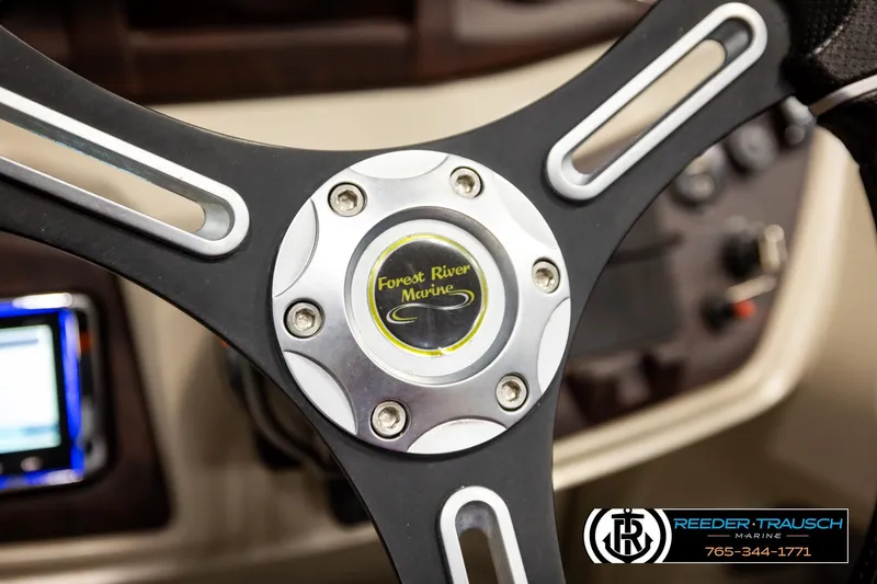 Slide: The Image of Steering wheel of 2019 Berkshire 24 SB2 CTS boat, featuring Forest River Marine logo. - 37