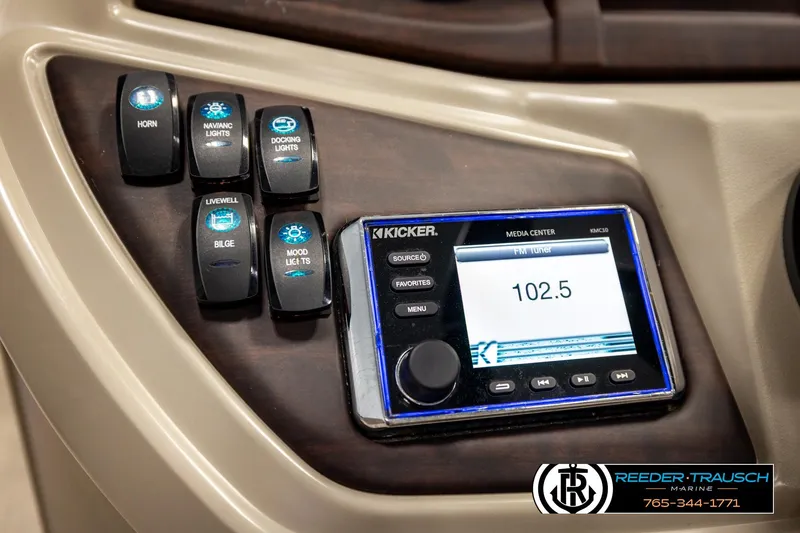 Slide: The Image of Control panel of 2019 Berkshire 24 SB2 CTS with Kicker media center and various switches. - 38