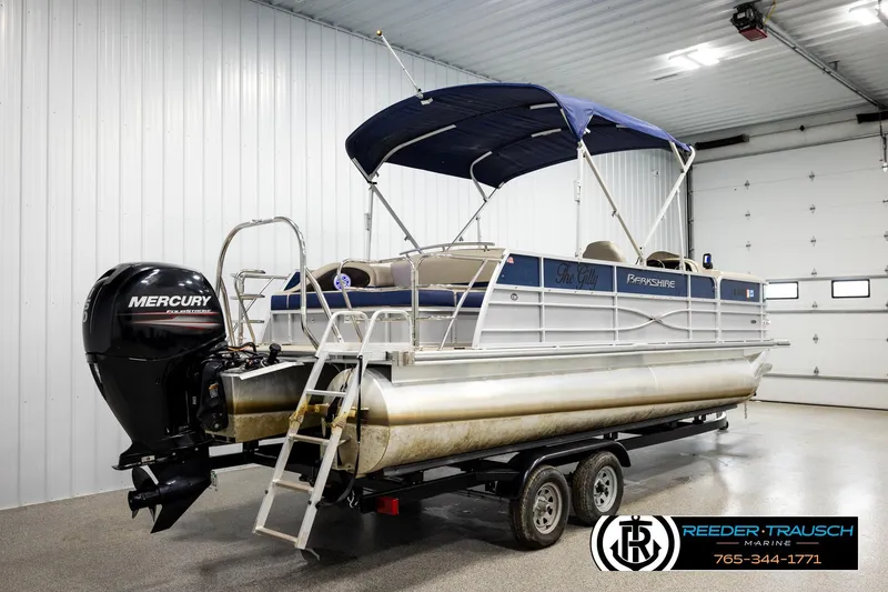 Slide: The Image of 2019 Berkshire 24 SB2 CTS pontoon boat with Mercury engine in a garage setting. - 6