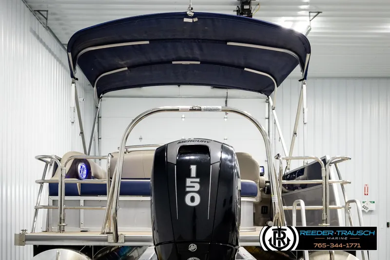 Slide: The Image of 2019 Berkshire 24 SB2 CTS pontoon boat with Mercury 150 engine in indoor storage. - 7
