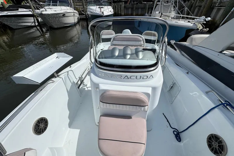 Slide: The Image of 2022 Barracuda 188 CCR boat docked, featuring sleek seating and modern design. - 15