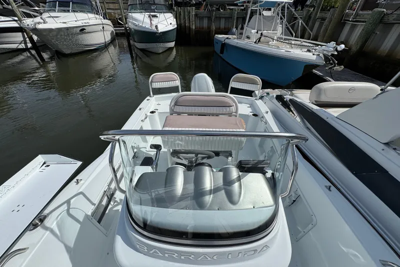 Slide: The Image of 2022 Barracuda 188 CCR boat docked among other vessels in a marina. - 16