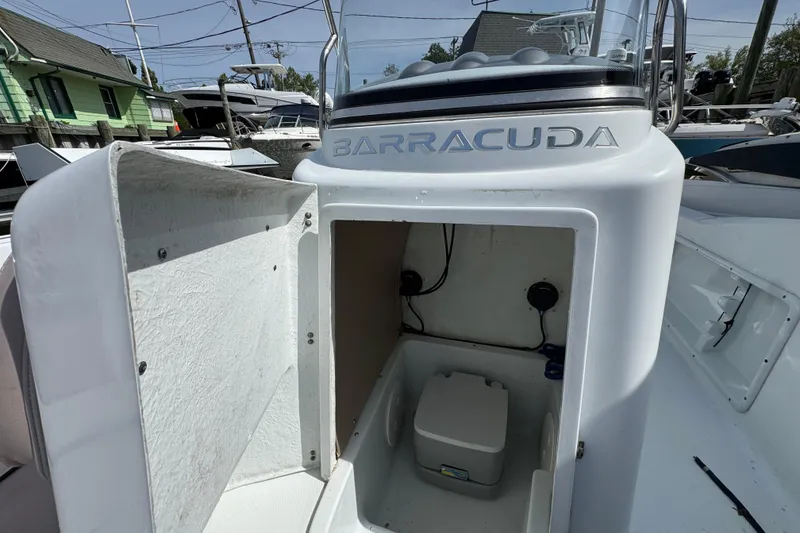 Slide: The Image of 2022 Barracuda 188 CCR boat with open storage compartment and visible equipment. - 17