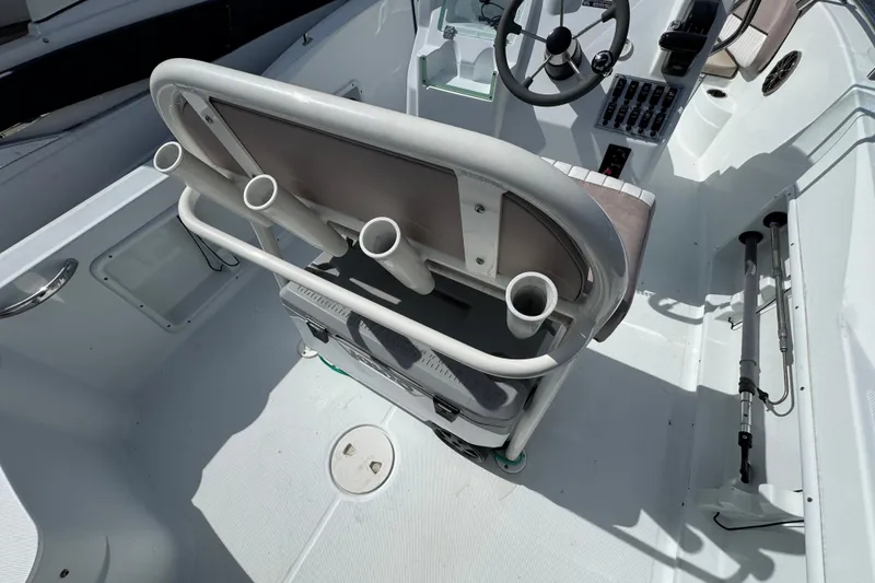 Slide: The Image of 2022 Barracuda 188 CCR boat interior with steering wheel and rod holders. - 4