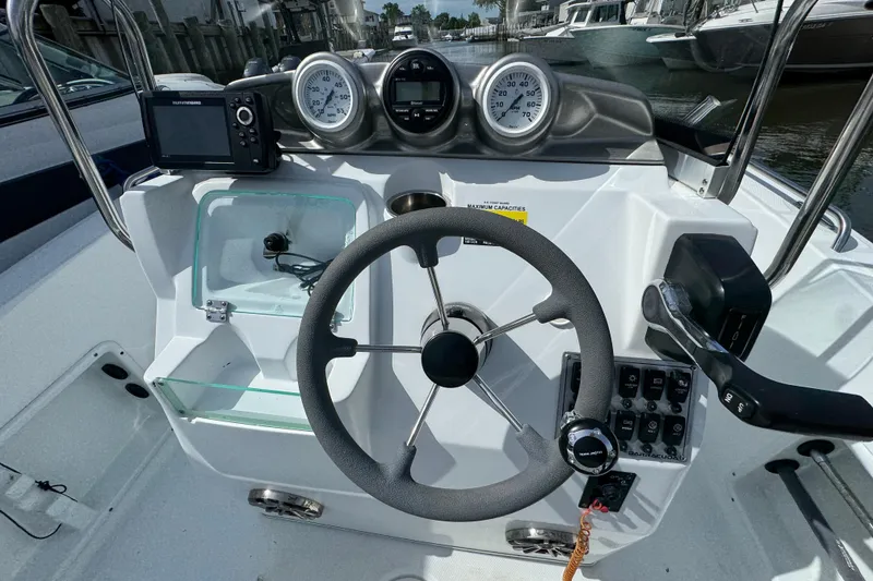 Slide: The Image of 2022 Barracuda 188 CCR boat dashboard with steering wheel and gauges. - 6