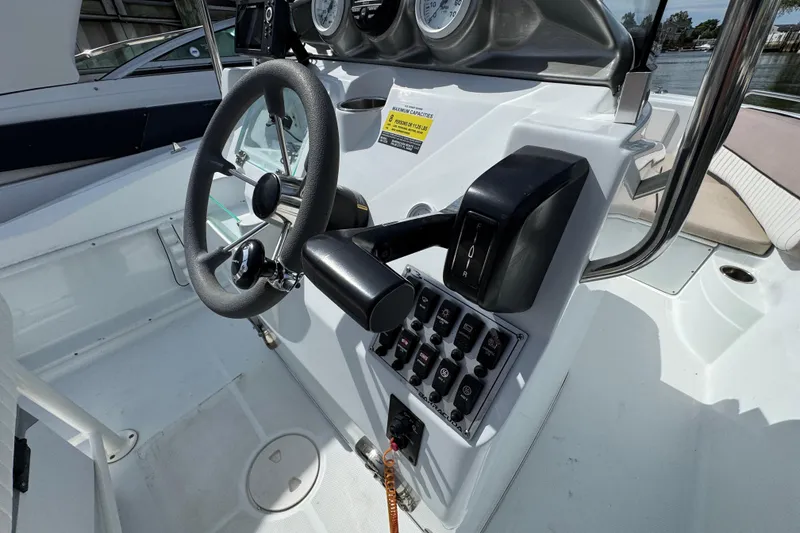 Slide: The Image of 2022 Barracuda 188 CCR boat dashboard with steering wheel and control panel. - 8