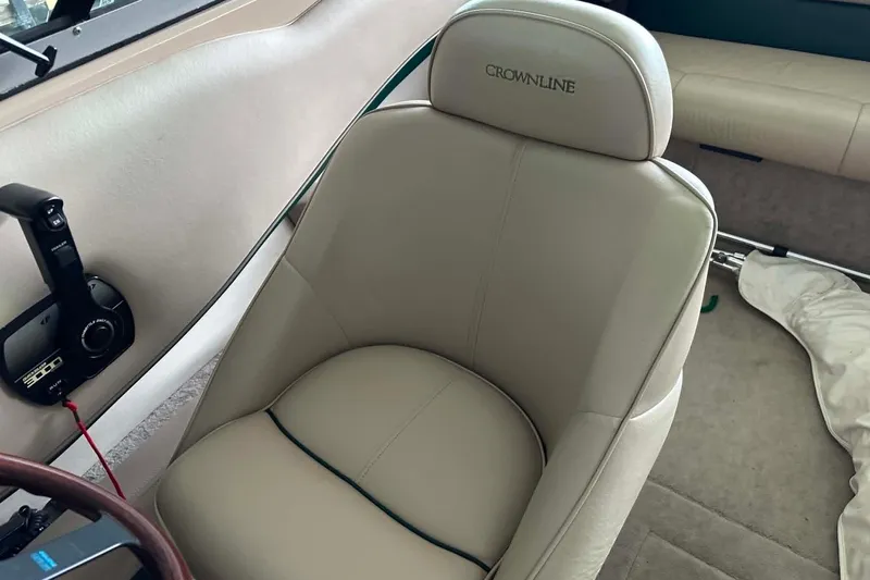 Slide: The Image of Interior of a 1997 Crownline 225 BR boat featuring a beige captain's seat. - 2