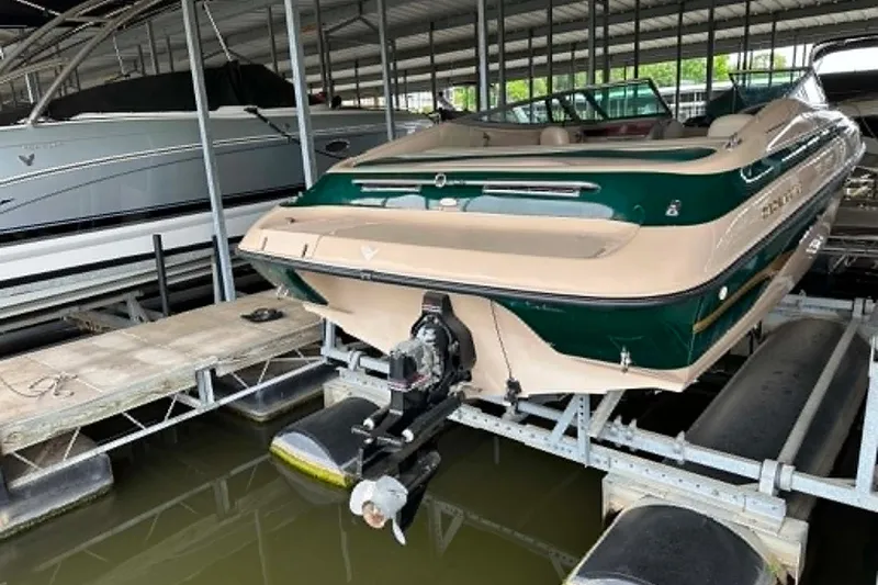 Slide: The Image of 1997 Crownline 225 BR boat docked in a covered marina. - 4