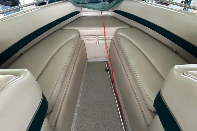 Slide: The Image of Interior of a 1997 Crownline 225 BR boat with beige seating and green accents. - 6