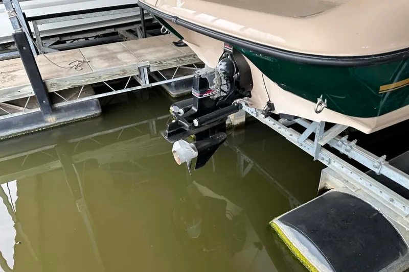 Slide: The Image of 1997 Crownline 225 BR boat on a dock, showing the stern and propeller. - 8