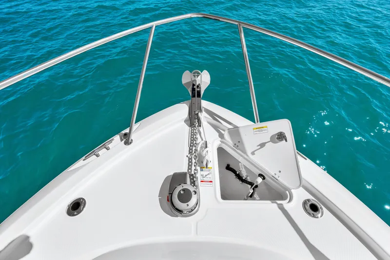 Slide: The Image of The bow of a boat with an anchor and blue water in the background. - 41