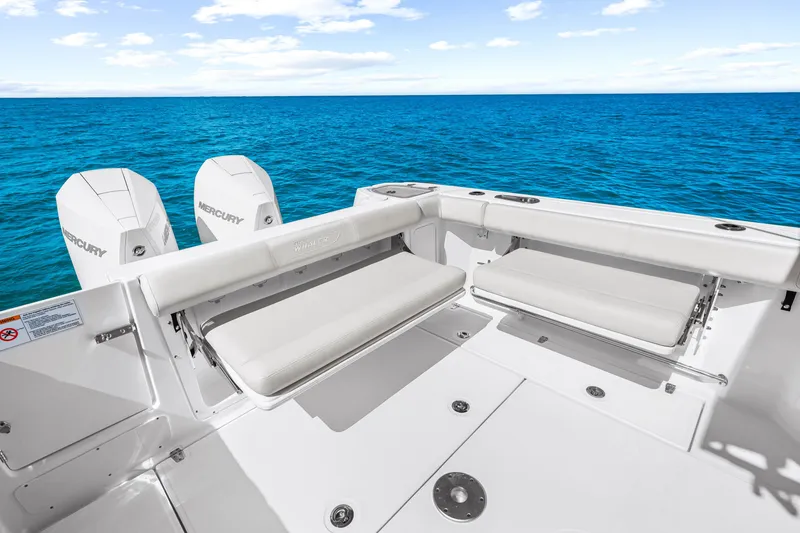 Slide: The Image of The image shows the stern of a Boston Whaler 285 Conquest boat with two Mercury engines and foldable seats. - 21