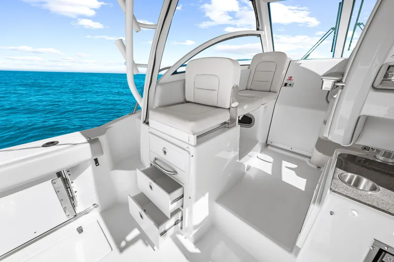 Slide: The Image of The image shows the cockpit of a 2027 Boston Whaler 285 Conquest with white seats and a blue sea backdrop. - 30