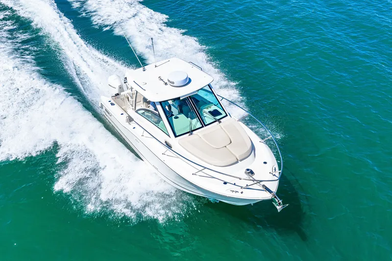 Slide: The Image of A 2027 Boston Whaler 285 Conquest speeding across the blue water. - 16
