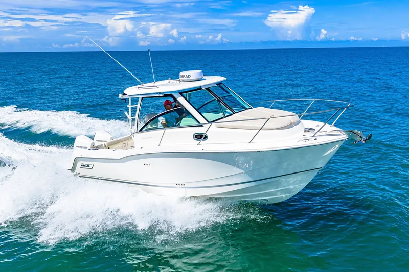 Slide: The Image of A 2027 Boston Whaler 285 Conquest speeds across the blue sea under a clear sky. - 15