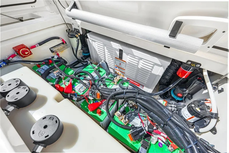 Slide: The Image of The engine compartment of a 2027 Boston Whaler 285 Conquest shows batteries and wiring. - 27