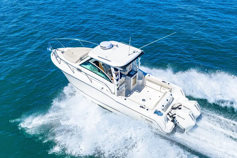 Slide: The Image of A 2027 Boston Whaler 285 Conquest speeding across the blue water. - 6