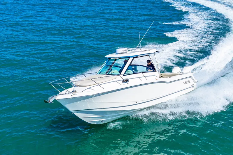 Slide: The Image of A 2027 Boston Whaler 285 Conquest speeding across blue waters. - 12