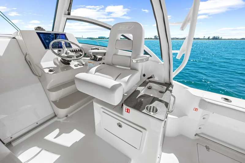 Slide: The Image of The 2027 Boston Whaler 285 Conquest cockpit features a modern helm with a comfortable seat. - 29
