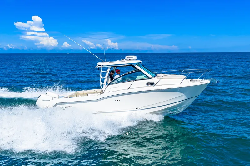 Slide: The Image of A 2027 Boston Whaler 285 Conquest speeds across the blue sea under a clear sky. - 8