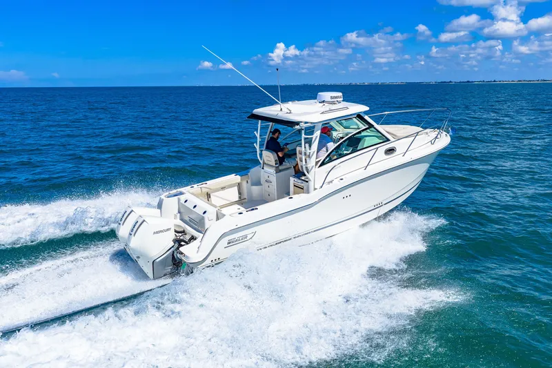 Slide: The Image of A 2027 Boston Whaler 285 Conquest speeds across the blue sea under a clear sky. - 9