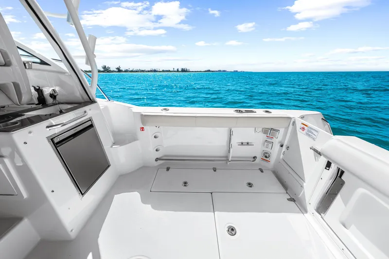 Slide: The Image of The image shows the cockpit of a 2027 Boston Whaler 285 Conquest. It's spacious and modern, overlooking the blue sea. - 25