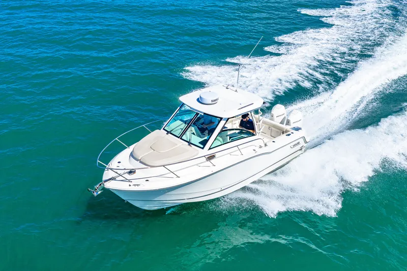 Slide: The Image of A 2027 Boston Whaler 285 Conquest speeds across the blue water. - 14
