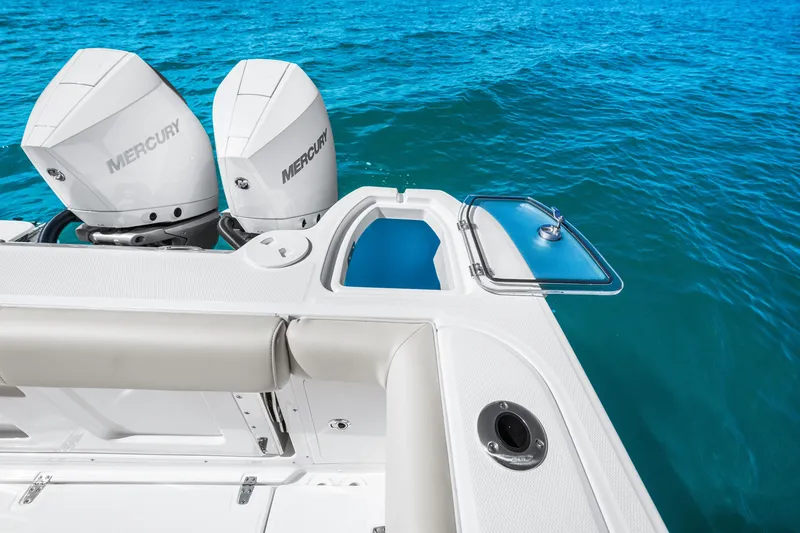 Slide: The Image of The image shows the stern of a Boston Whaler 285 Conquest with two Mercury engines. - 24
