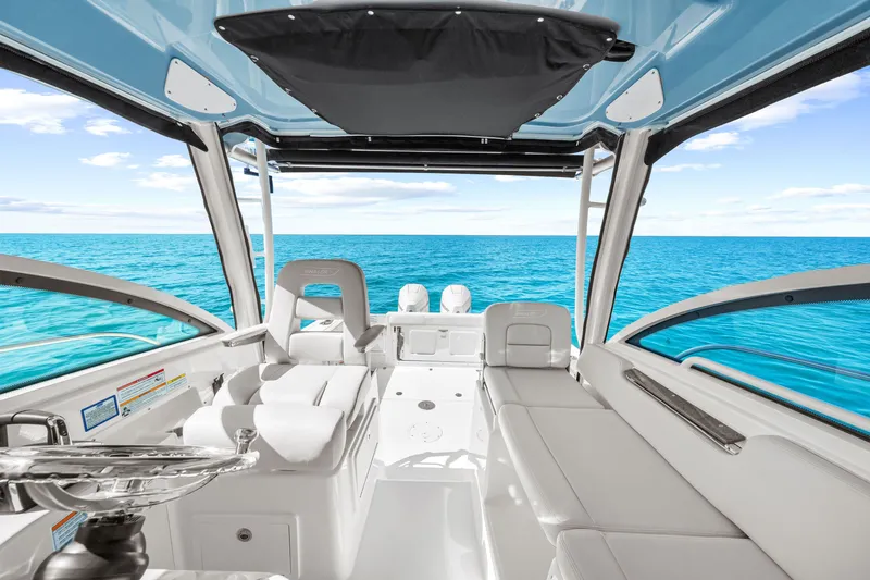 Slide: The Image of The image shows the cockpit of a 2027 Boston Whaler 285 Conquest overlooking the open sea. - 35