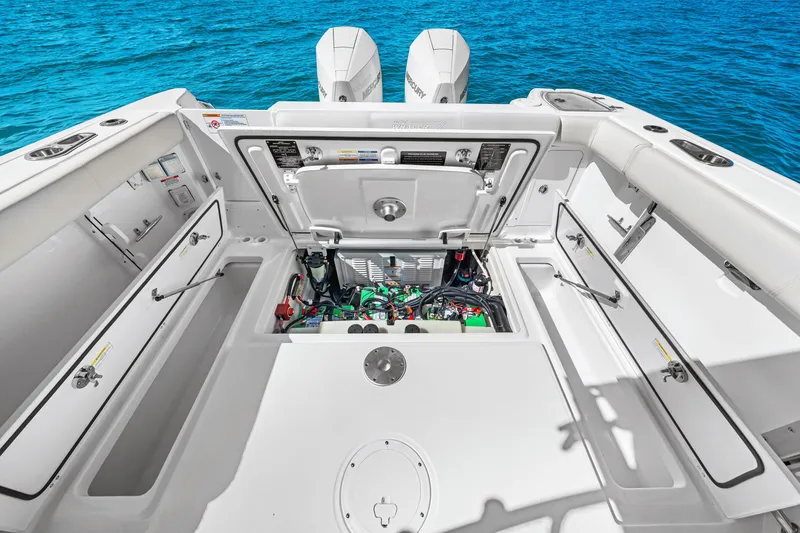 Slide: The Image of The image shows the cockpit of a Boston Whaler 285 Conquest with open storage compartments and engine access. - 26