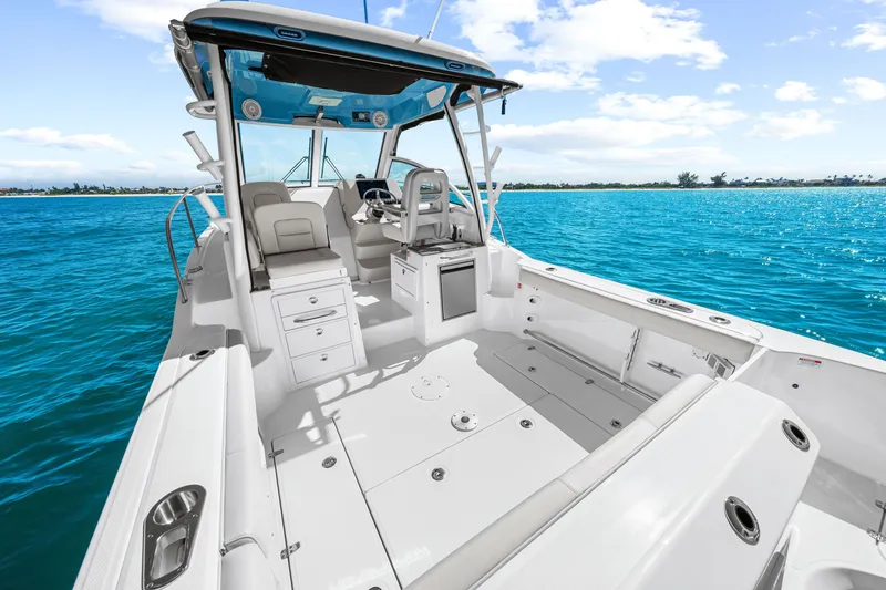 Slide: The Image of The image shows a Boston Whaler 285 Conquest boat on open water. It features a spacious deck and modern helm. - 18
