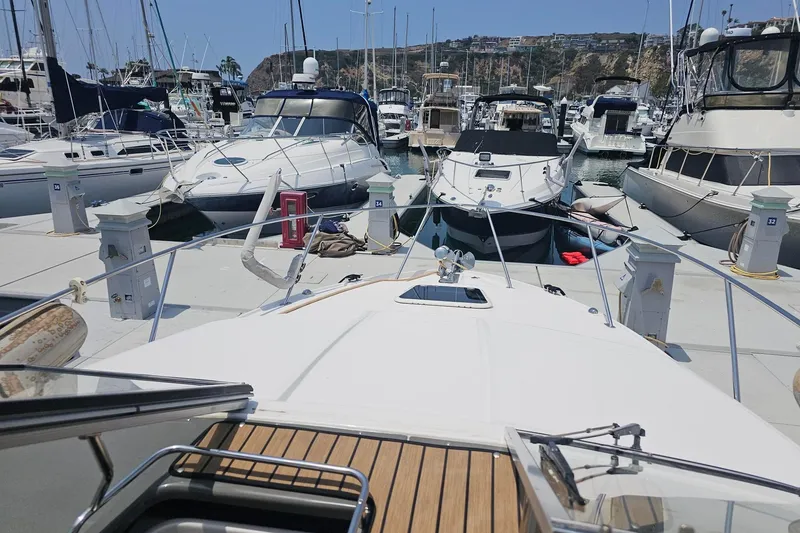 Slide: The Image of 2009 Regal 2860 Window Express docked among other boats in a marina. - 18