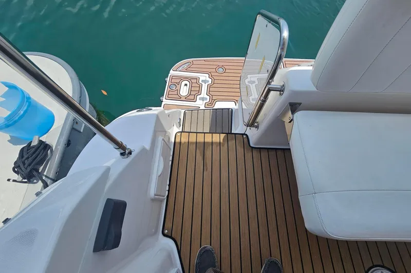 Slide: The Image of 2009 Regal 2860 Window Express boat deck with teak flooring and white seating. - 19