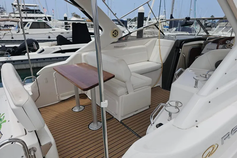 Slide: The Image of 2009 Regal 2860 Window Express boat interior with seating and wooden table at marina. - 21